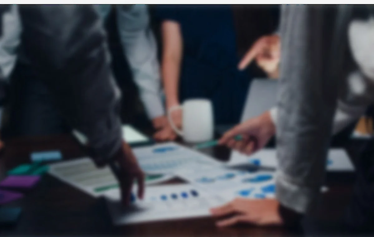 Professionals reviewing business information around a table